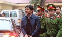 Cảnh sát dẫn giải ông Đinh La Thăng đến phiên tòa. Ảnh: TTXVN.