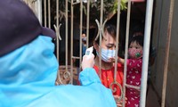Nhân viên y tế đến từng nhà đo thân nhiệt cho người dân tại Mê Linh - Hà Nội. Ảnh: Mạnh Thắng