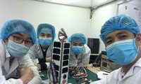 Nhóm kỹ sư của Trung tâm Vũ trụ Việt Nam bên vệ tinh NanoDragon Ảnh: Trung tâm Vũ trụ Việt Nam cung cấp 