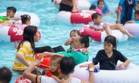 Người TP.HCM tấp nập bơi lội giải nhiệt ngày mùng 2 Tết ở công viên nước Đầm Sen