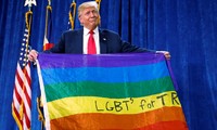 Tổng thống Mỹ Trump cầm lá cờ 7 màu của cộng đồng LGBTQ. Ảnh: Reuters