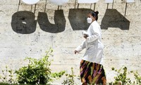 Một phụ nữ đeo khẩu trang đi bộ ở thủ đô Havana (Cuba). Ảnh: Tân Hoa Xã