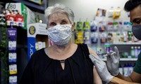 Một cụ bà tiêm vắc-xin mũi tăng cường tại một hiệu thuốc ở Mỹ. Ảnh: Reuters