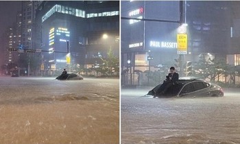 Anh chàng “chill” trên mui ô tô giữa mưa to ngập đường ở Hàn Quốc, dân mạng vội tìm "in tư"