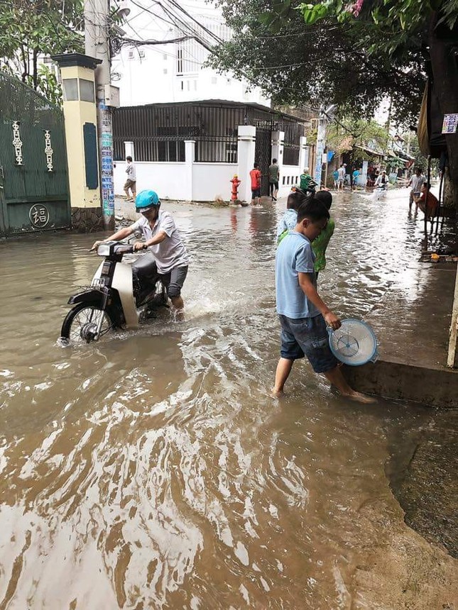 Người dân Sài Gòn di chuyển vất vả trên những con đường ngập đầy nước sau trận bão ảnh 9