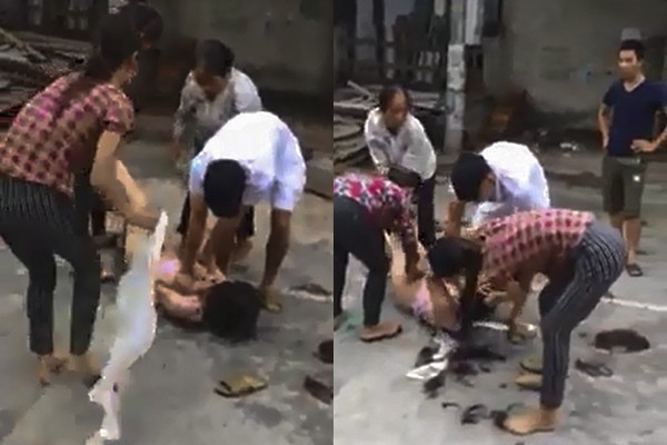 Cô gái bị nhóm người hành hung, lột đồ, cắt tóc một cách dã man. Ảnh cắt từ video.