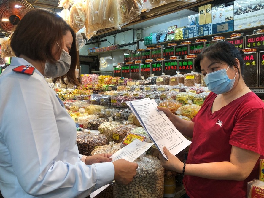 Tiểu thương chợ Phạm Văn Hai trưng giấy tờ hàng hóa cho đoàn kiểm tra