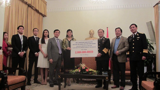 Ông Jonathan Hạnh Nguyễn và gia đình trao tiền quyên góp cho Thứ trưởng Quốc phòng, Đô đốc Nguyễn Văn Hiến. Ảnh: Bình Giang