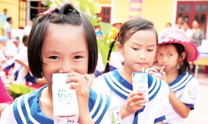 Học sinh trường Tiểu học Hòa Sơn (huyện Ðô Lương, Nghệ An) với niềm vui được uống sữa tại trường.