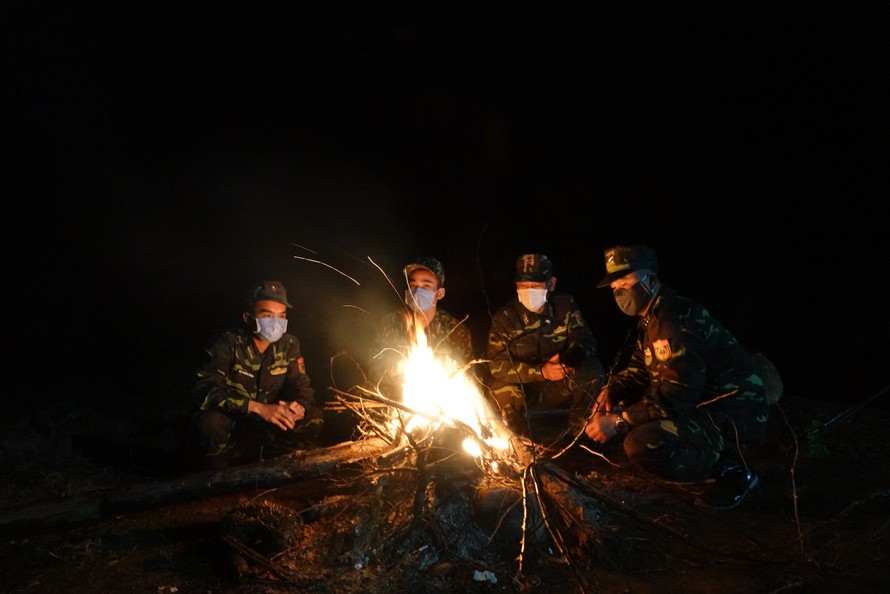 Đêm lạnh và sương giá, đội hình biên phòng ở chốt 1322 đốt lửa sưởi ấm, ngay phía sau họ là đường biên Việt - Trung. Ảnh: Nguyễn Minh