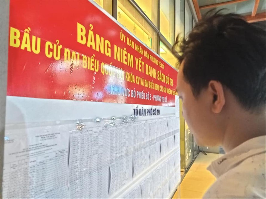 Người dân theo dõi danh sách cử tri được niêm yết tại phường Yên Sở, quận Hoàng Mai, Hà Nội. Ảnh: LD 