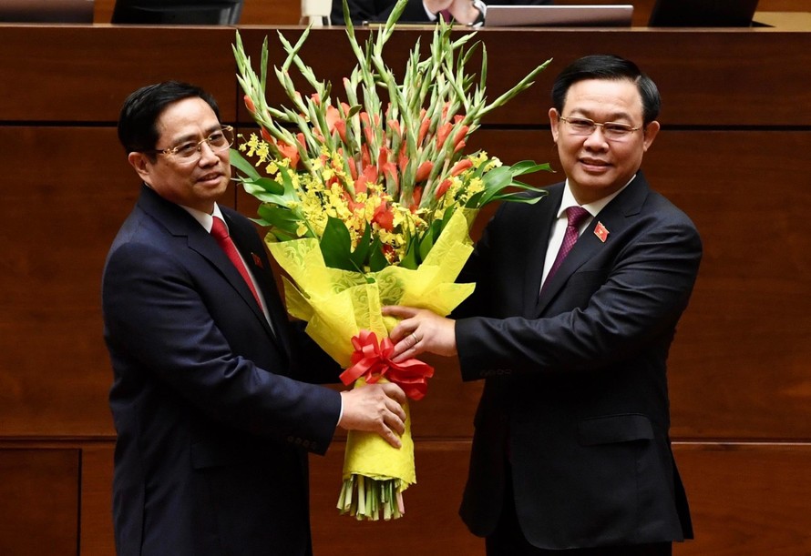 Chủ tịch Quốc hội tặng hoa chúc mừng Thủ tướng. Ảnh Như Ý