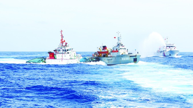 Tàu kiểm ngư của Việt Nam (giữa) bị các tàu Trung Quốc đâm, phun vòi rồng. Ảnh: Việt Cường 