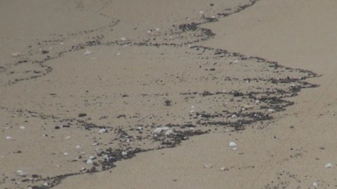 Dầu vón cục xuất hiện ở bờ biển Quảng Trị một tuần nay. Ảnh: Hoàng Táo/ VnExpress